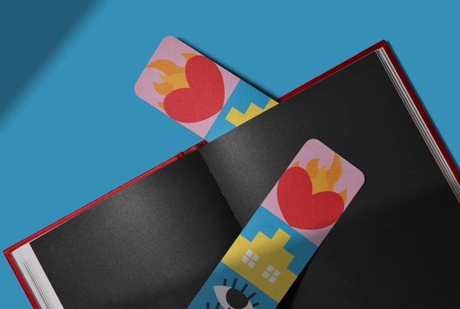Two bookmarks lying on the black pages of an open book: a column of coloured squares, a flaming heart at the top.